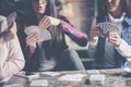 Three best friends in cafe playing together game cards. Royalty Free Stock Photo
