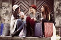 Three best friends enjoying after shopping. Young girls sitting Royalty Free Stock Photo