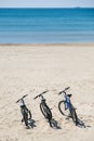 Three bicycles are on the beach on sea background Royalty Free Stock Photo