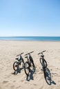 Three bicycles are on the beach on sea background Royalty Free Stock Photo