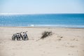 Three bicycles are on the beach on sea background Royalty Free Stock Photo