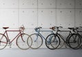 Three bicycles are lined up against a concrete wall with a grid pattern of circular indentations. Royalty Free Stock Photo
