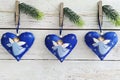 Three big hearts with angels pinned on wall with pine branches. Handmade baubles zero-waste Christmas. Royalty Free Stock Photo