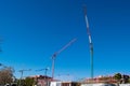 Three big high cranes under a new construction Royalty Free Stock Photo