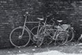 Three bikes in front of a stone wall