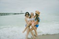 Three bikini asian woman happiness with relaxing emotion in vacation sea beach