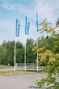 Three BILTEM flags fluttering in wind at entrance of Swedish store of spare parts, household goods on natural background