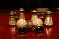 Three binoculars on a brown desk