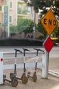 Three BIRD scooters next to yellow END sign