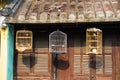 Three birdcages in front of old house