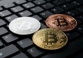 Three bitcoin coins on a computer keyboard Royalty Free Stock Photo