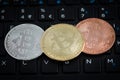 Three bitcoins on black keyboard Royalty Free Stock Photo