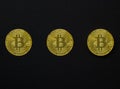 Three bitcoins on a dark background, wallpaper or texture Royalty Free Stock Photo