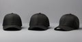 Three Black Baseball Caps on Grey Background with Copy Space Royalty Free Stock Photo