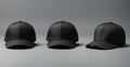 Three Black Baseball Caps on Grey Background with Copy Space Royalty Free Stock Photo