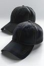 Of three black baseball caps isolated on white background, different angles, hyper realistic Royalty Free Stock Photo