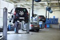 Three black cars stand in small service station and two men