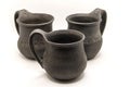 three black ceramic mugs on a white background Royalty Free Stock Photo