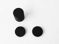 Three black circular objects on a white surface Royalty Free Stock Photo