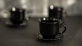 Three black coffee cups on black background Royalty Free Stock Photo