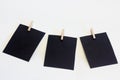 Three black frames on a white background with clothespins Royalty Free Stock Photo