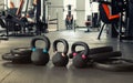 Three black kettlebells with five black plates in the gym Royalty Free Stock Photo