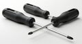 Three Black Phillips Head Screwdrivers on White Surface for Construction and Repair Royalty Free Stock Photo