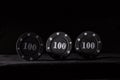 Three black poker chips on a dark background Royalty Free Stock Photo