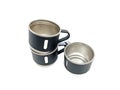 Three black stainless steel mugs arranged in a pyramid-like stack on a white background. Royalty Free Stock Photo