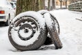 Three black tires in a snowy street
