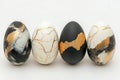 Three black and white eggs adorned with elegant gold designs, perfect for an Easter celebration. Royalty Free Stock Photo