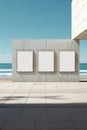 Three Blank Frames on a Concrete Wall Overlooking a Calm Sea Under a Clear Sky in a Modern Outdoor Environment Royalty Free Stock Photo