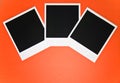 Three blank instant photo frames on red background with copy space top view Royalty Free Stock Photo