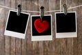 Three blank instant photos hanging on the clothesline Royalty Free Stock Photo