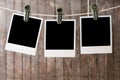 Three blank instant photos hanging on the clothesline Royalty Free Stock Photo