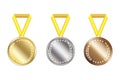 Three blank medals. Three awards with yellow ribbons. Gold, silver and bronze medals. Stock image. Royalty Free Stock Photo