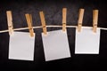 Three Blank paper notes hanging on rope with clothes pins Royalty Free Stock Photo