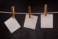 Three Blank paper notes hanging on rope with clothes pins Royalty Free Stock Photo