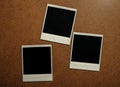 Three blank photo frames on brown table Royalty Free Stock Photo