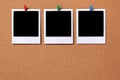 Three blank polaroid frame photo prints cork background copy space