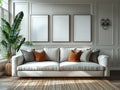 Three blank frames on the wall in a living room with a white sofa and a plant Royalty Free Stock Photo