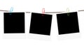 Three blank polaroid frames hanging on a rope Royalty Free Stock Photo