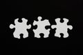 Three blank puzzle pieces inline unlinked on black background Royalty Free Stock Photo