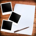 Three blank retro polaroid photo frames and white paper and pen Royalty Free Stock Photo