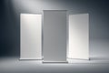 Three blank roll-up banners standing in a studio. 3D Rendering Royalty Free Stock Photo