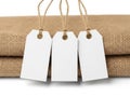 Three blank tags on burlap fabric isolated on white background Royalty Free Stock Photo