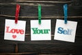 Love your self in squre paper notes hanging by clothespin Royalty Free Stock Photo