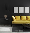 Three blank vertical poster frames mock up in modern luxury living room interior with black wall and bright yellow sofa, Royalty Free Stock Photo