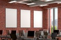 Three blank vertical posters mock up on the red brick wall in office interior. Royalty Free Stock Photo