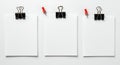 Three blank white papers clipped to a white surface Royalty Free Stock Photo